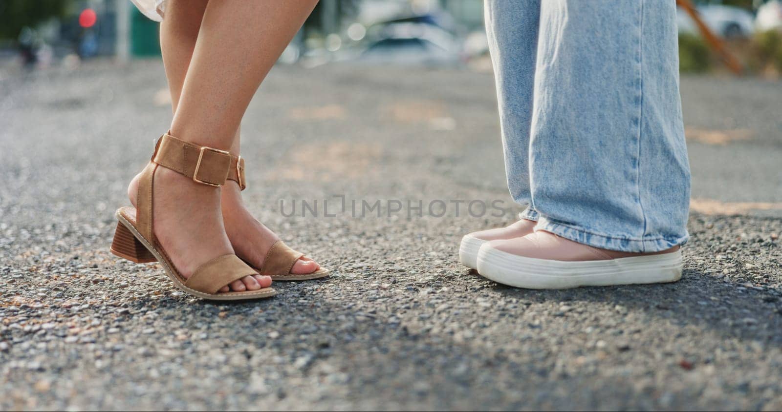 Feet, closeup and women in a road, shy and flirting while on their first date in a city. Shoes, lgbtq and lesbian couple sharing cute, romance and gay relationship, bonding and standing in a street by YuriArcurs