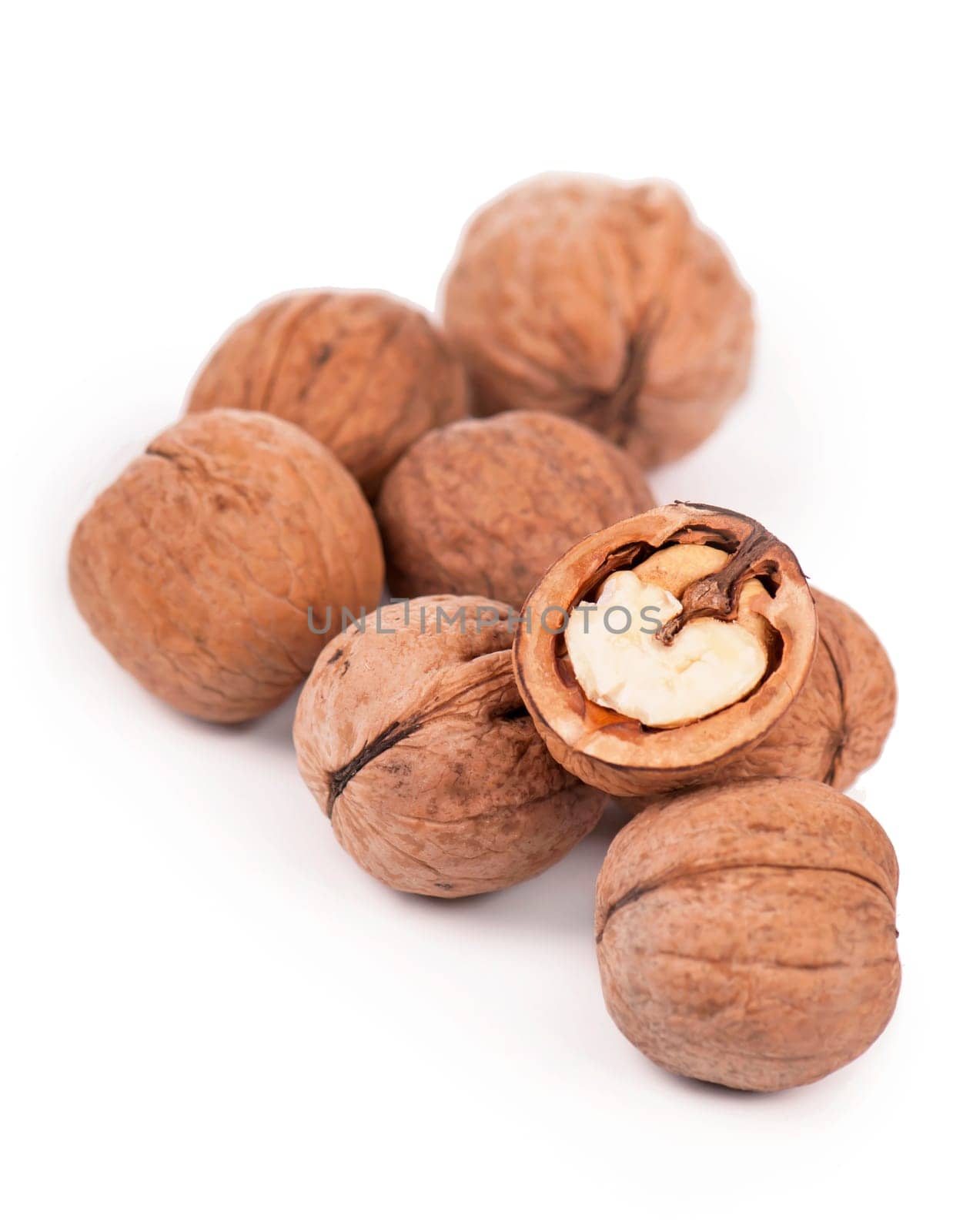 . Fresh ripe Walnut with dried leaves isolated on a white background. by aprilphoto