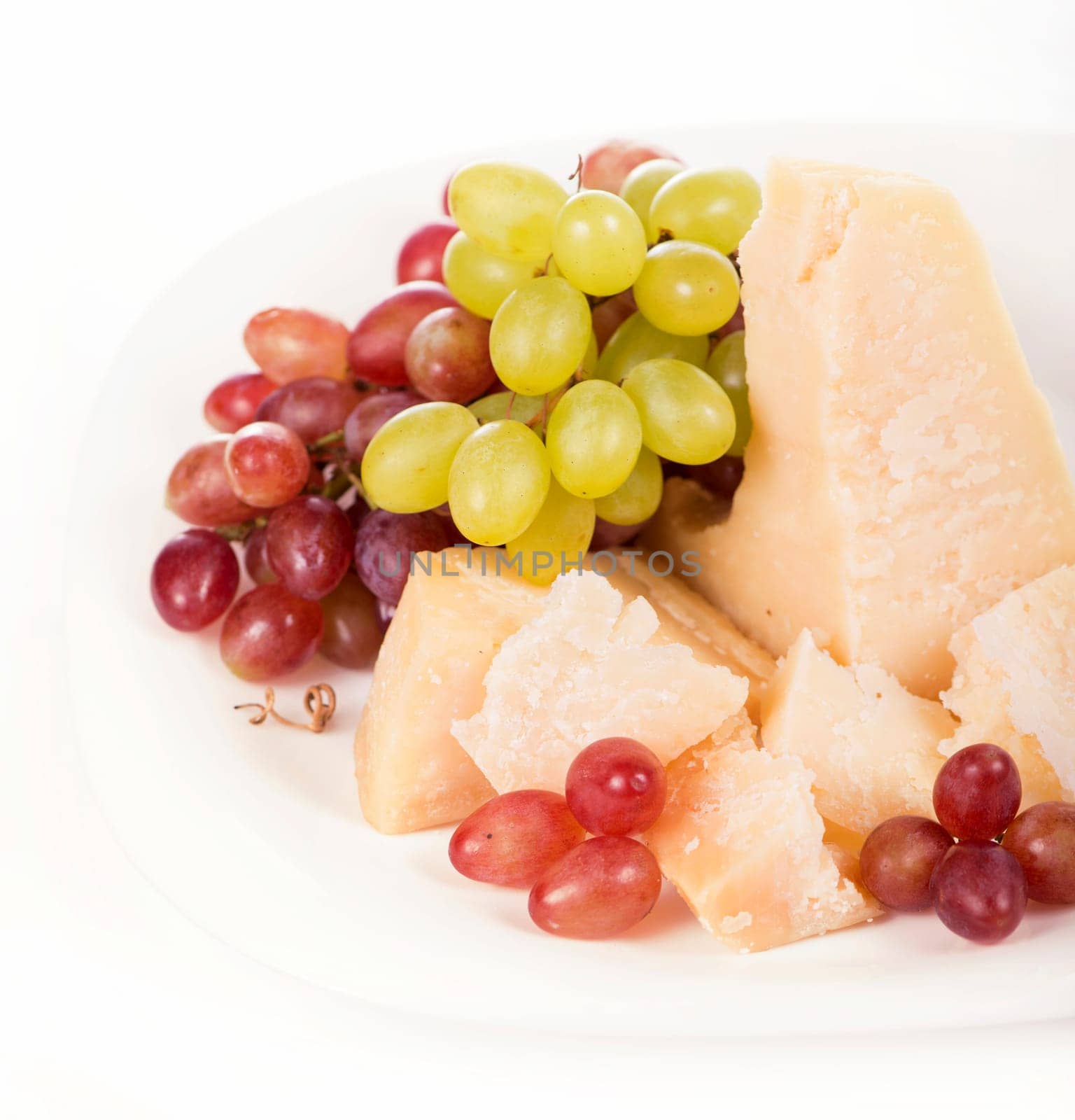 Parmesan cheese and grapes isolated on a white backgroun. View from above