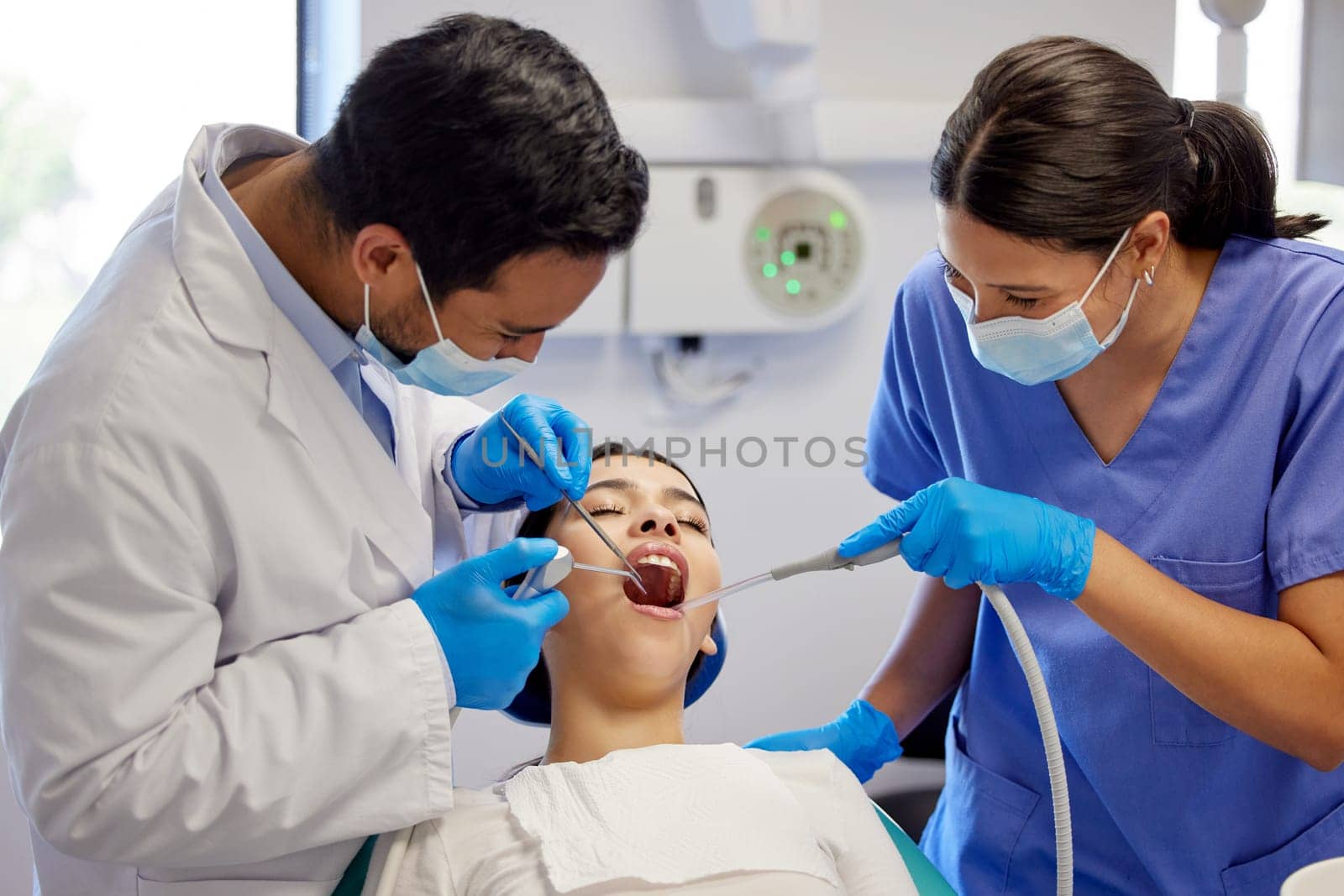 Getting right down to the root cause. a young woman having a dental procedure performed on her. by YuriArcurs