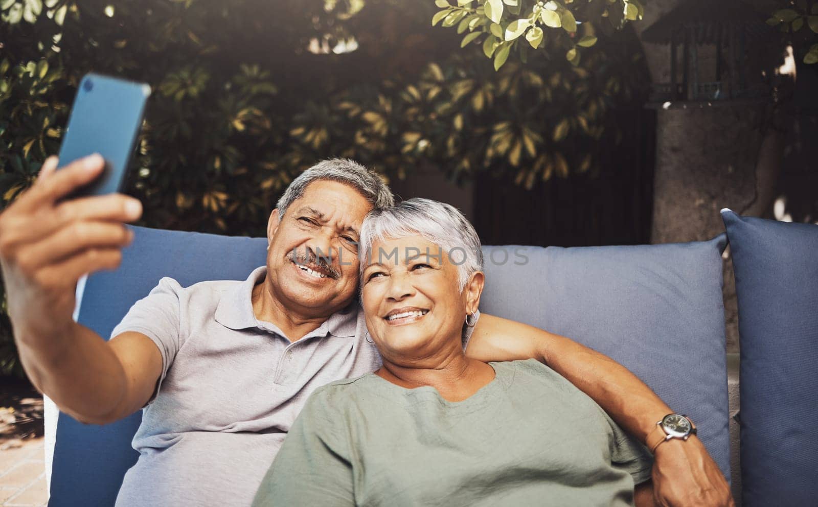 Relax, smile and senior couple with a selfie on an outdoor couch during retirement holiday in Spain. Happy, communication and elderly man and woman with a photo for a memory, streaming and social app.
