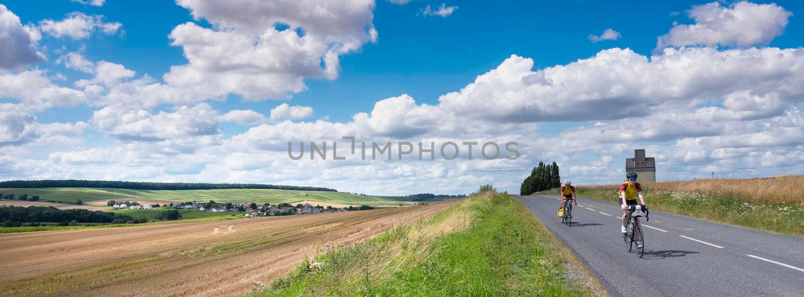 people on sport bicycle in french countryside south of reims in france by ahavelaar