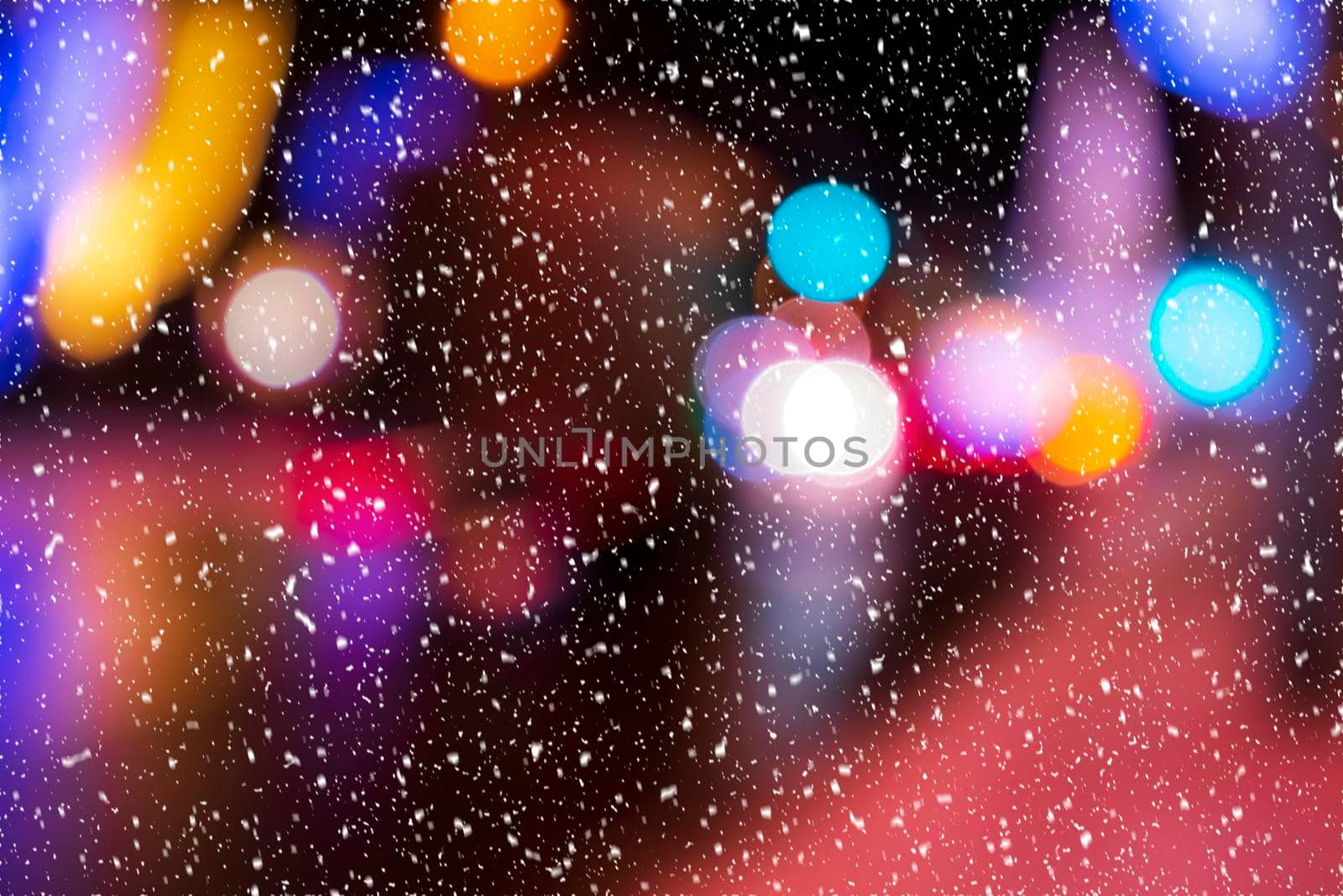 Blurred lights of headlights of cars and lanterns in the night city in a snowfall. Abstract bokeh. by Eugene_Yemelyanov