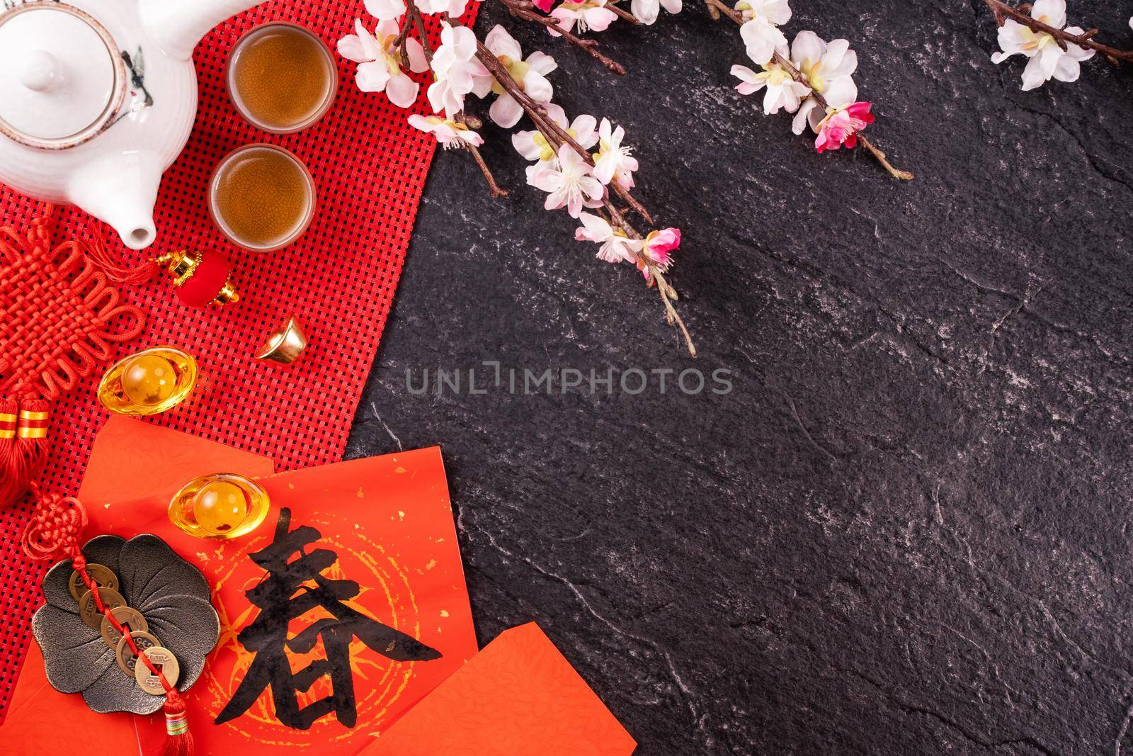 Design concept of Chinese lunar January new year - Festive accessories, red envelopes (ang pow, hong bao), top view, flat lay, overhead above. The word 'chun' means coming spring.