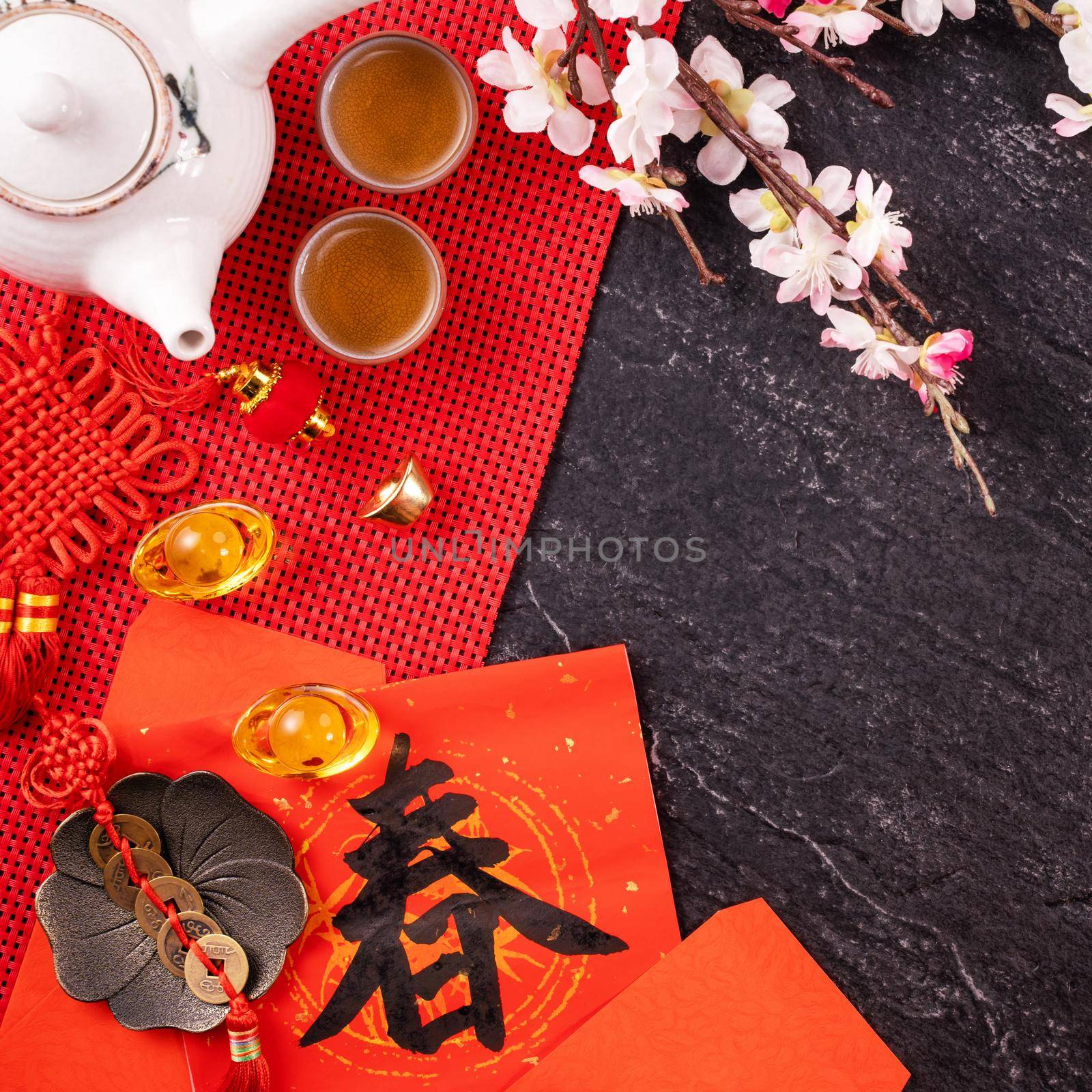 Design concept of Chinese lunar January new year - Festive accessories, red envelopes (ang pow, hong bao), top view, flat lay, overhead above. The word 'chun' means coming spring.