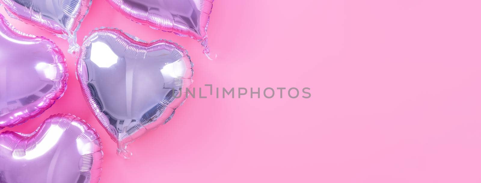 Valentine's Day romantic design concept - Beautiful real heart shape foil balloon isolated on pale pink background, top view, flat lay, overhead above photography. by ROMIXIMAGE