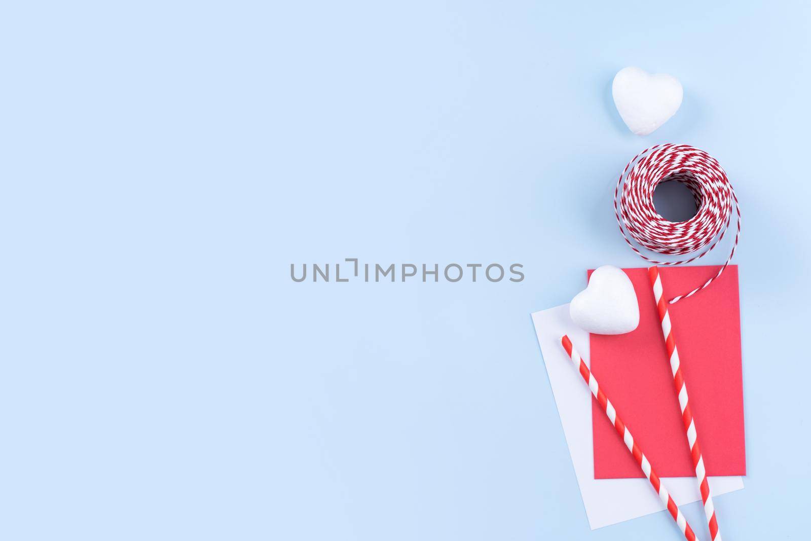 Valentine's Day, Mother's day art design concept for promotion - Red, white wrapped gift box isolated on pastel light blue color background, flat lay, top view. by ROMIXIMAGE