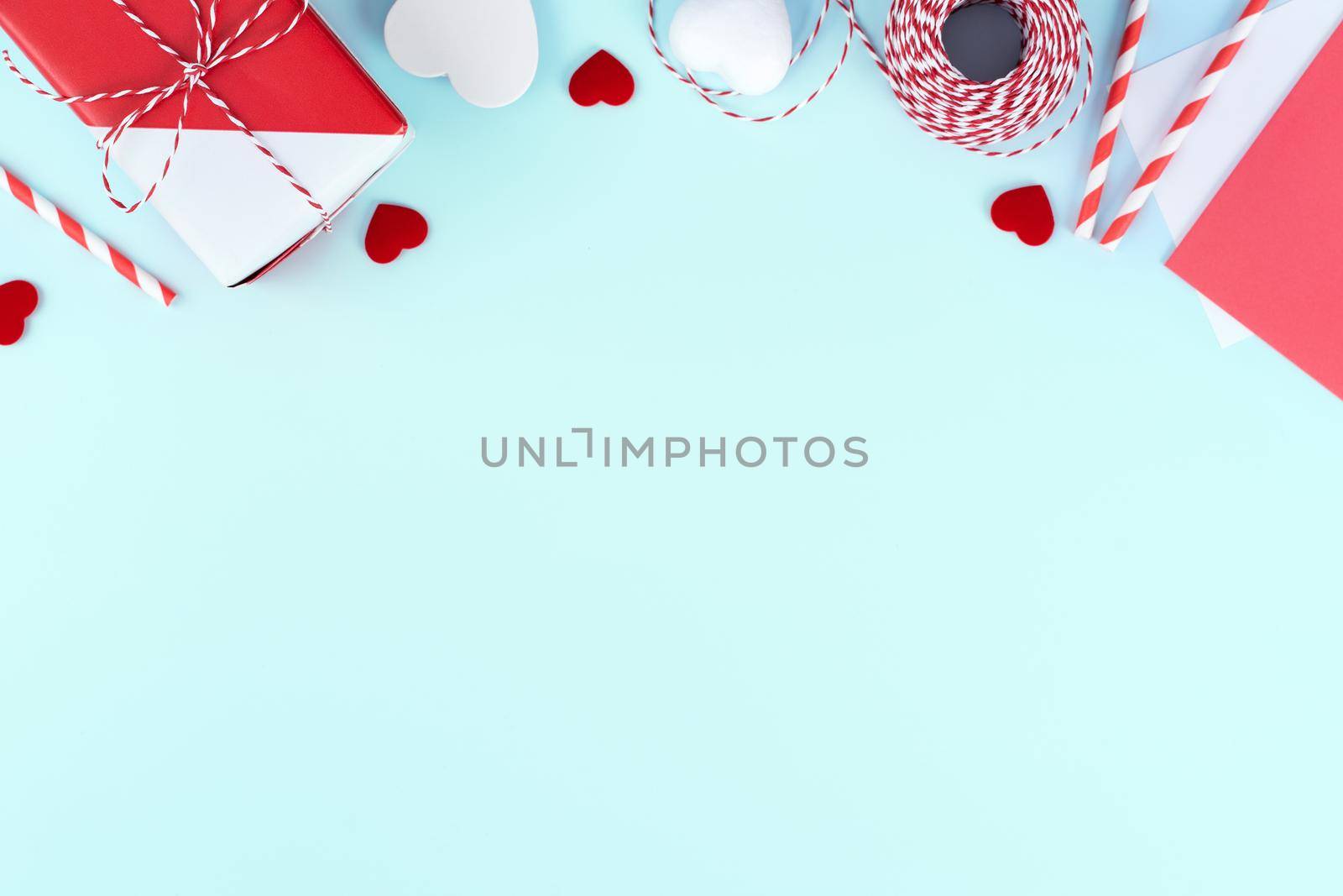 Valentine's Day, Mother's day art design concept for promotion - Red, white wrapped gift box isolated on pastel light blue color background, flat lay, top view. by ROMIXIMAGE