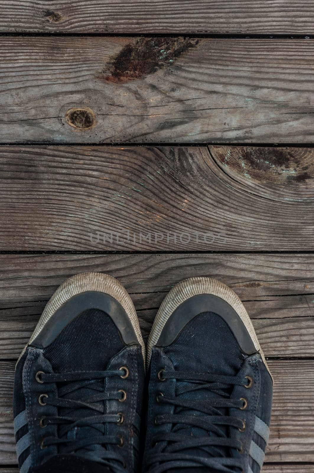 Blue pair sneakers standing on wooden floor. Top view by inxti