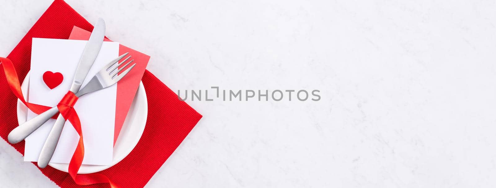 Valentine's Day, Mother's Day, holiday dating meal, banquet design concept - White plate and red ribbon on marble background, top view, flat lay. by ROMIXIMAGE