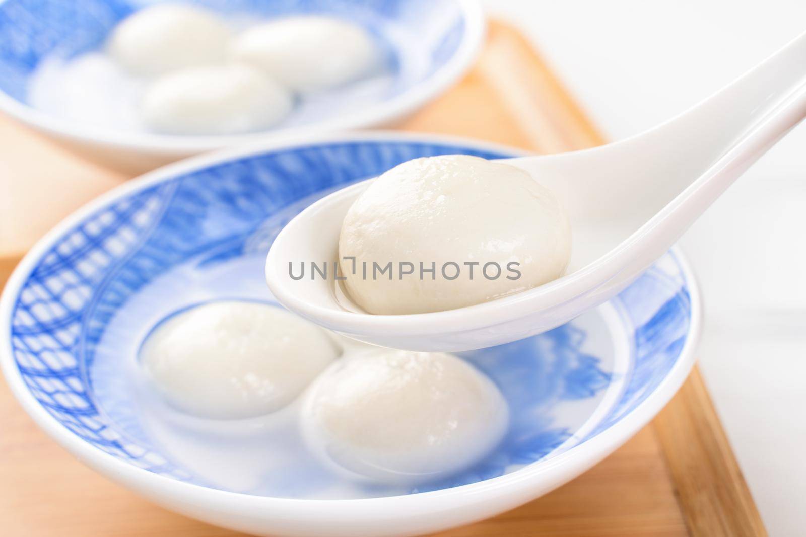 Delicious tang yuan, yuanxiao in a small bowl. Asian traditional festive food rice dumplings ball with stuffed fillings for Chinese Lantern Festival, close up.