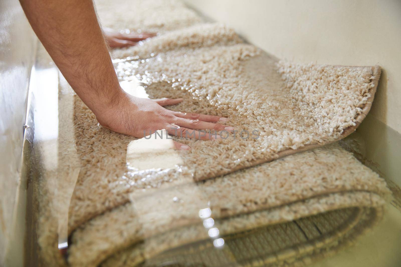 Dirty carpet soaking in special chemical liquid in carpet cleaning service