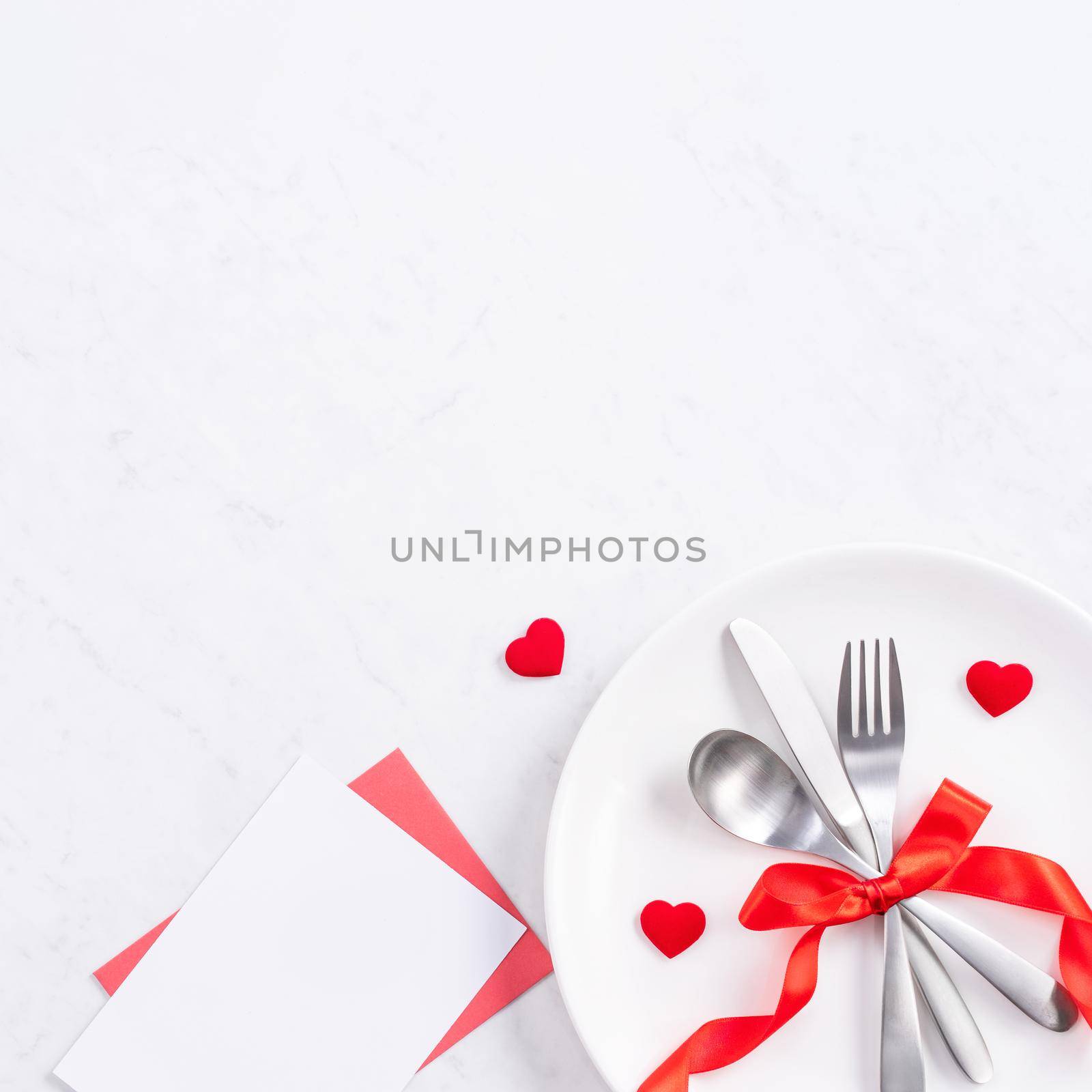 Valentine's Day, Mother's Day, holiday dating meal, banquet design concept - White plate and red ribbon on marble background, top view, flat lay.