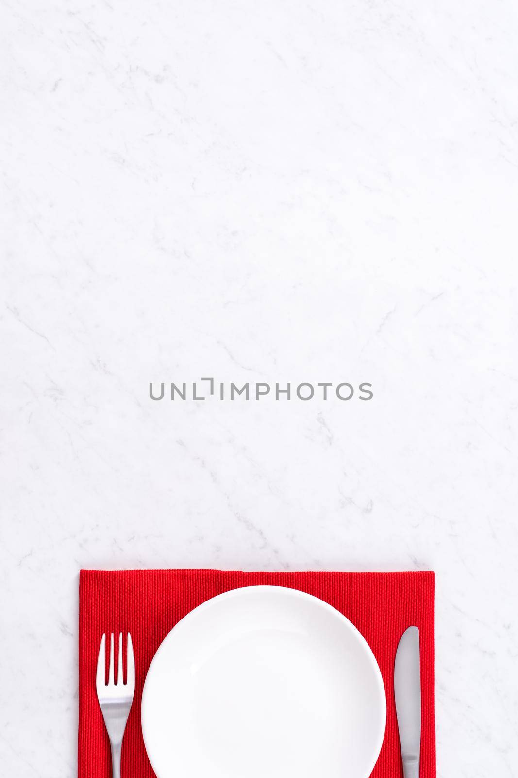 Valentine's Day, Mother's Day, holiday dating meal, banquet design concept - White plate and red ribbon on marble background, top view, flat lay. by ROMIXIMAGE