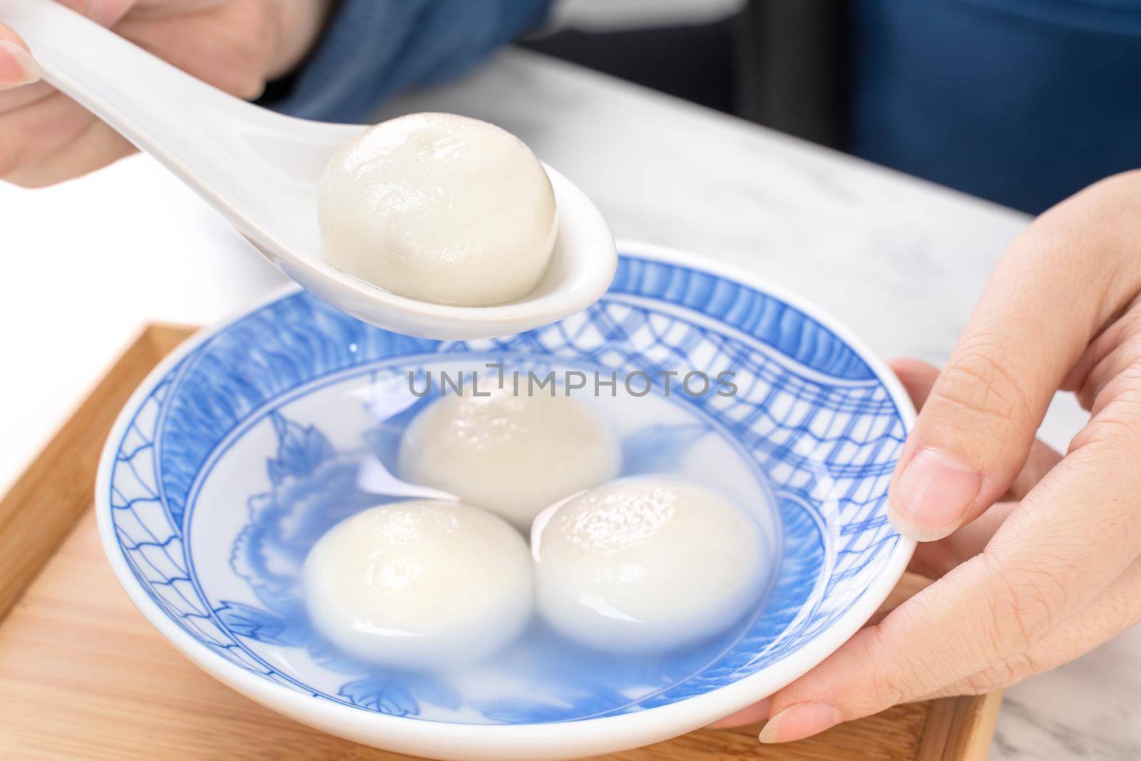 Delicious tang yuan, yuanxiao in a small bowl. Asian traditional festive food rice dumplings ball with stuffed fillings for Chinese Lantern Festival, close up.