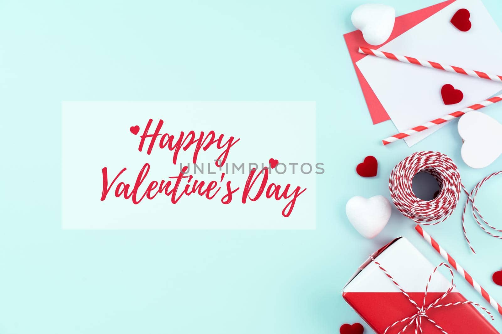 Valentine's Day handmade gift with greeting word design concept - Wrapped gift box isolated on pastel light blue color background, flat lay, top view. by ROMIXIMAGE