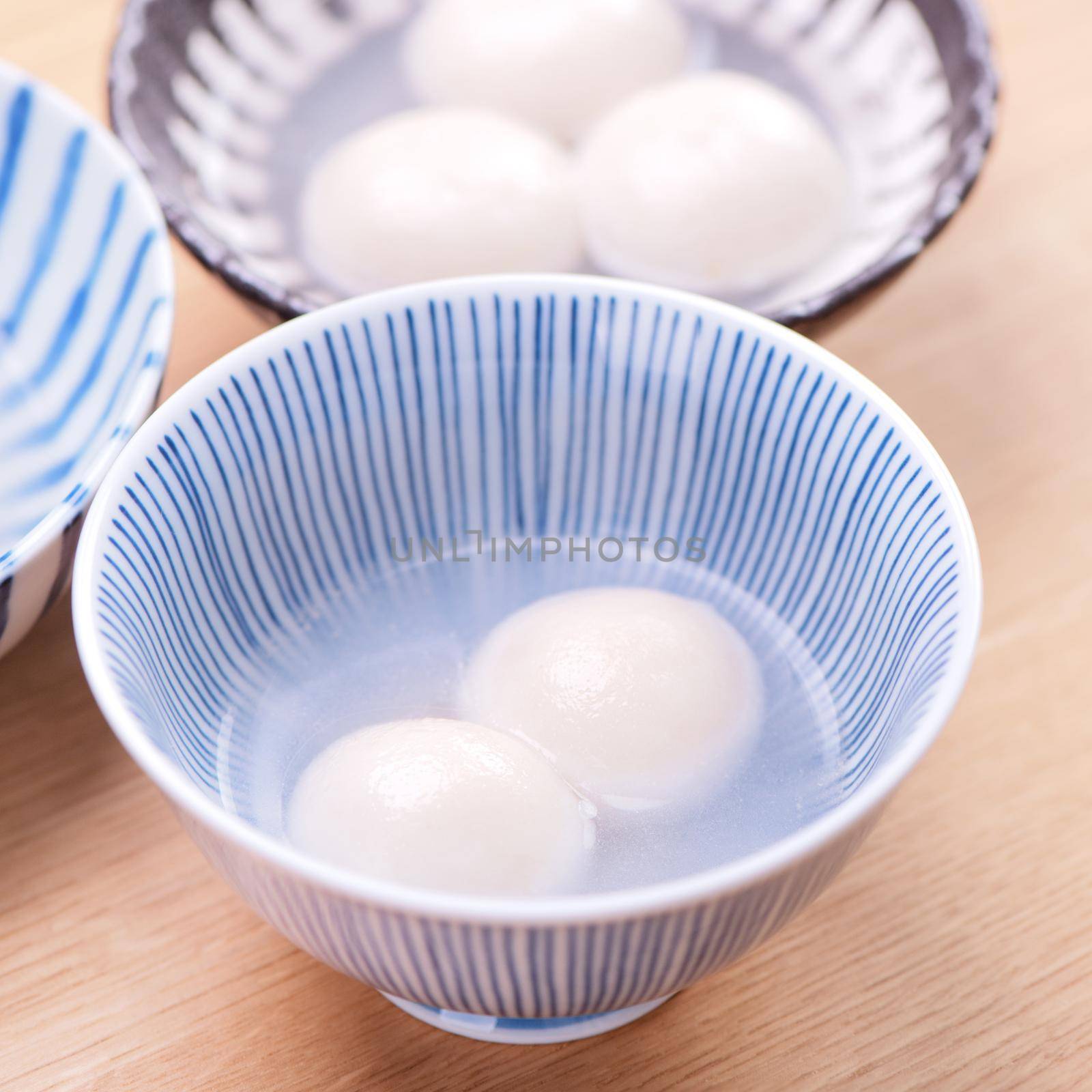 Tang yuan, tangyuan, yuanxiao in a small bowl. Delicious asian traditional festive food rice dumpling balls with stuffed fillings for Chinese Lantern Festival, close up. by ROMIXIMAGE