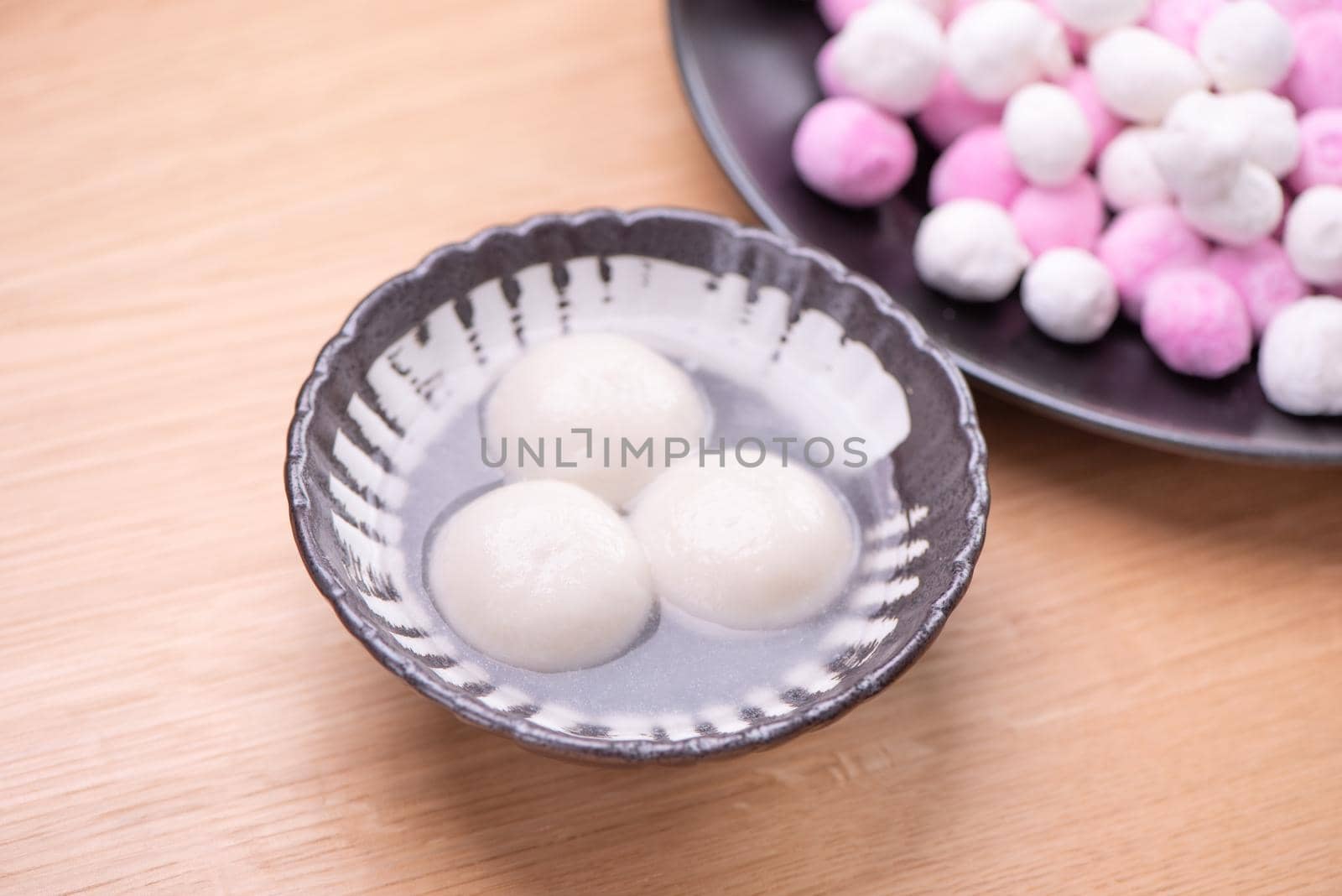 Delicious tang yuan, yuanxiao in a small bowl. Traditional festive food rice dumplings ball with stuffed fillings for Chinese Lantern Festival, close up.