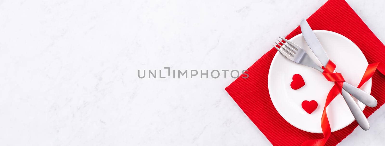 Valentine's Day, Mother's Day, holiday dating meal, banquet design concept - White plate and red ribbon on marble background, top view, flat lay. by ROMIXIMAGE