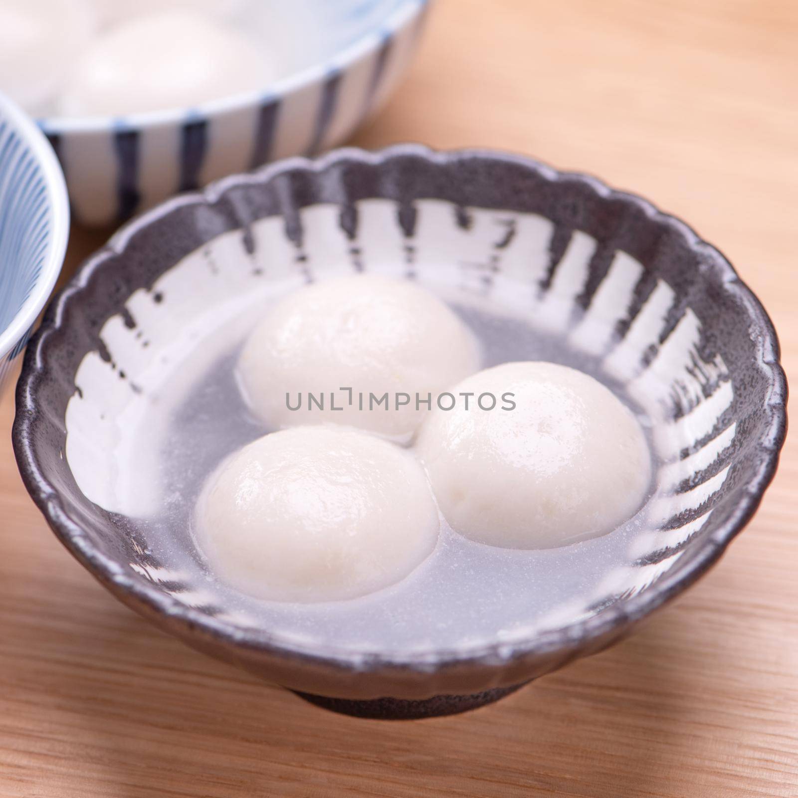 Tang yuan, tangyuan, yuanxiao in a small bowl. Delicious asian traditional festive food rice dumpling balls with stuffed fillings for Chinese Lantern Festival, close up. by ROMIXIMAGE