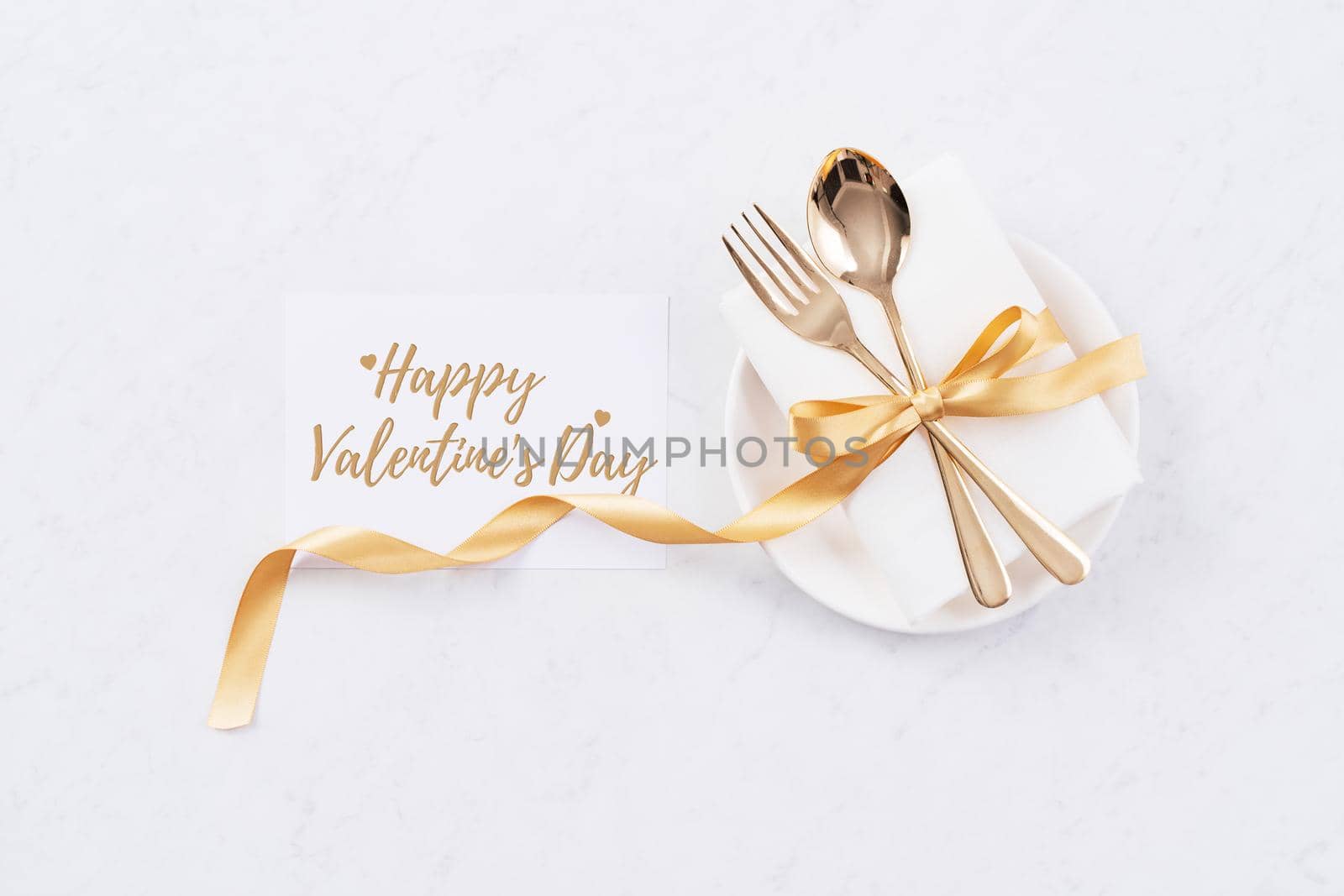 Valentine's Day holiday dating meal, banquet greeting card design concept - White plate and golden color tableware on marble background, top view, flat lay. by ROMIXIMAGE