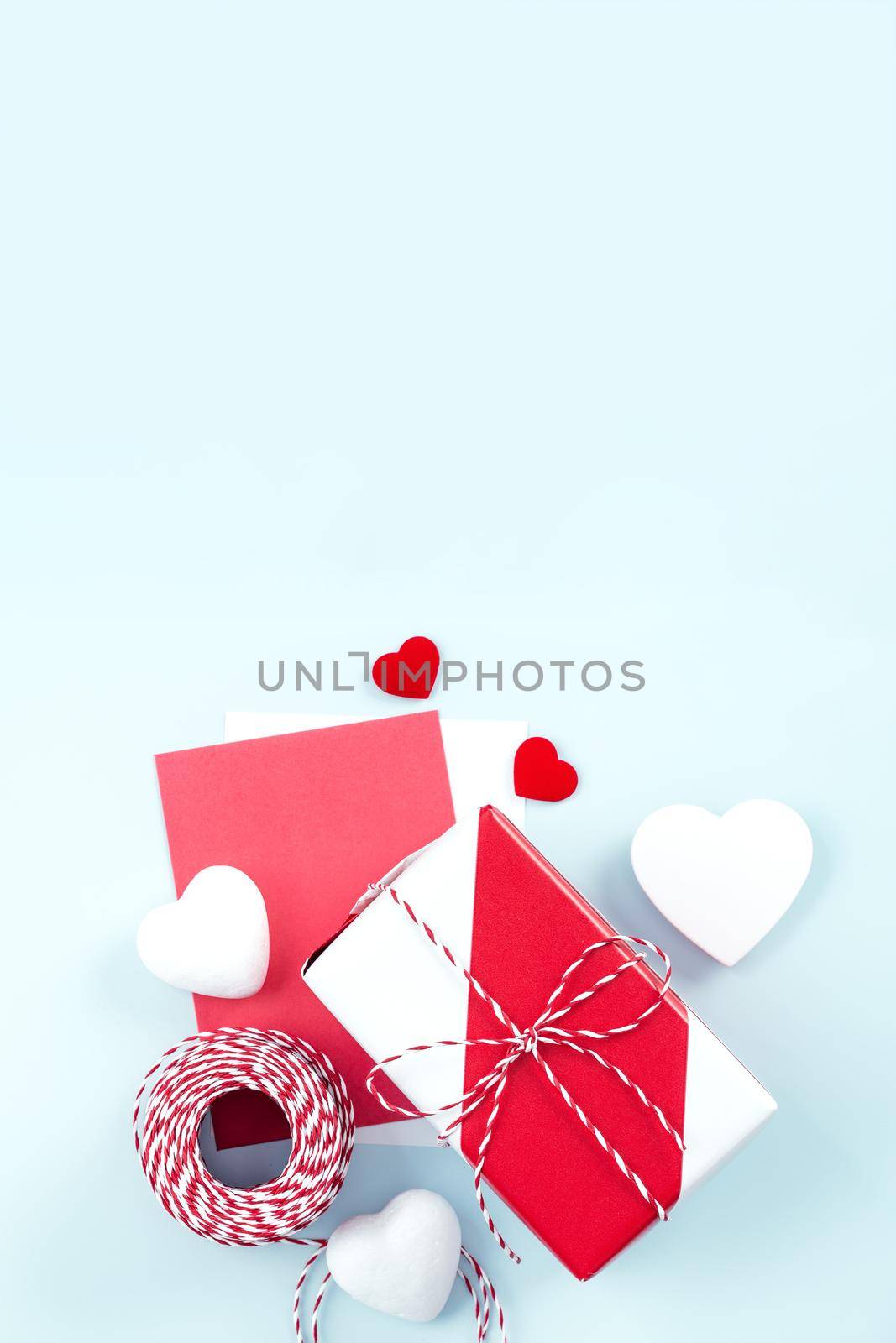 Mother's day, Valentine's Day handmade gift design concept - Wrapped gift box isolated on pastel light blue color background, flat lay, top view.