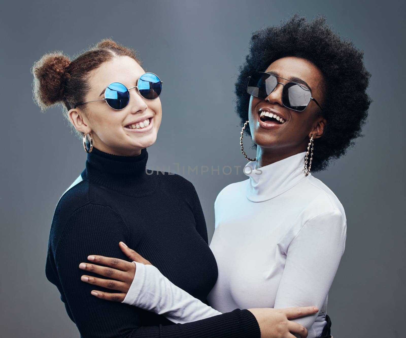 Fashion, futuristic and women smile in sunglasses, cyberpunk and trendy designer brand with gen z youth. Marketing, diversity and contemporary style with vision and edgy against studio background by YuriArcurs