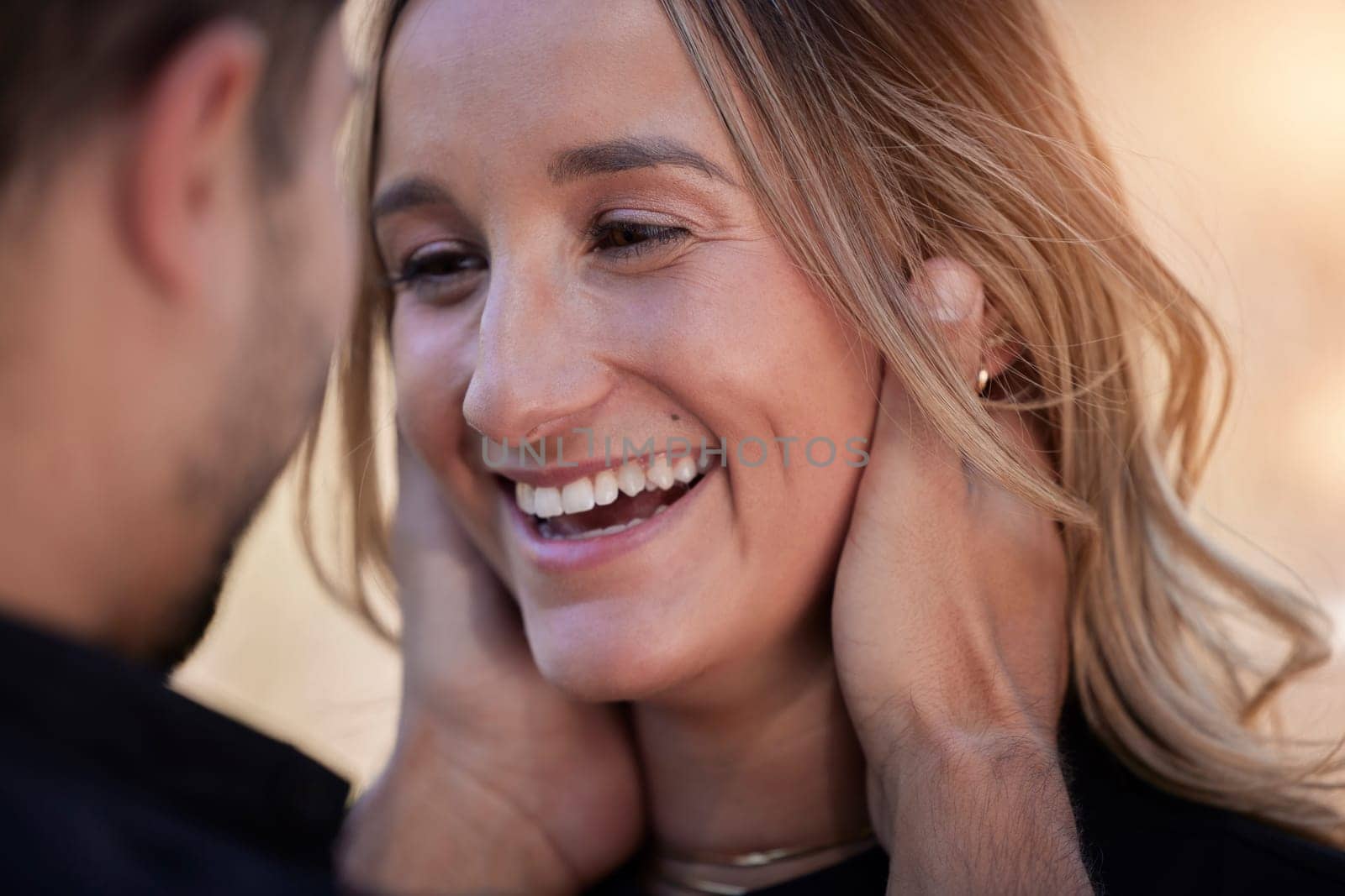 Love, happy and woman looking at her boyfriend while on romantic date for valentines day. Happiness, smile and man holding the face of girlfriend to bond with intimacy, affection and romance outdoors.