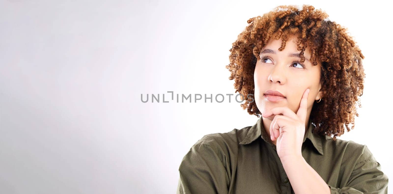 Face, thinking and mockup with a black woman in studio on a gray background for product placement. Idea, space and mock up with an attractive young female posing on a wall of empty branding space.