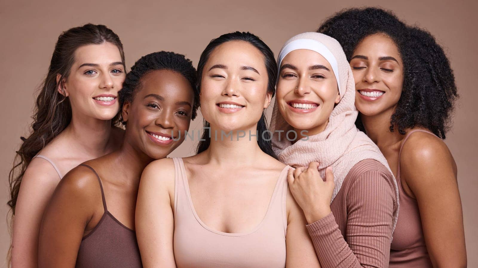 Support, diversity and women smile for skincare, beauty and empowerment against a studio background. Makeup, solidarity and face portrait of cosmetic model friends with happiness for cosmetics by YuriArcurs