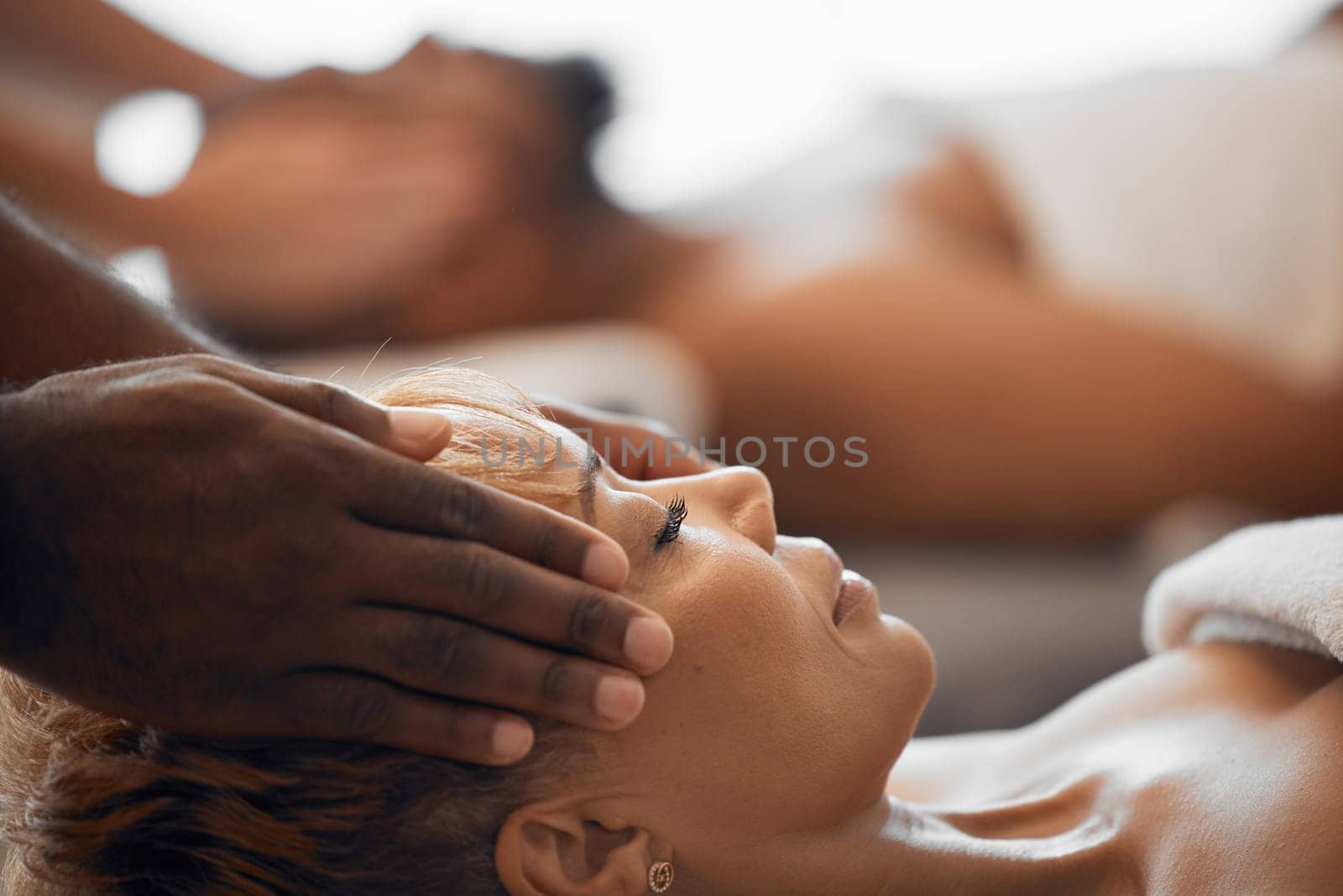 Woman, head massage and couple at beauty spa for facial treatment, wellness and luxury physical therapy for stress relief, zen and calm. Skincare salon therapist, black woman face and relax vacation.