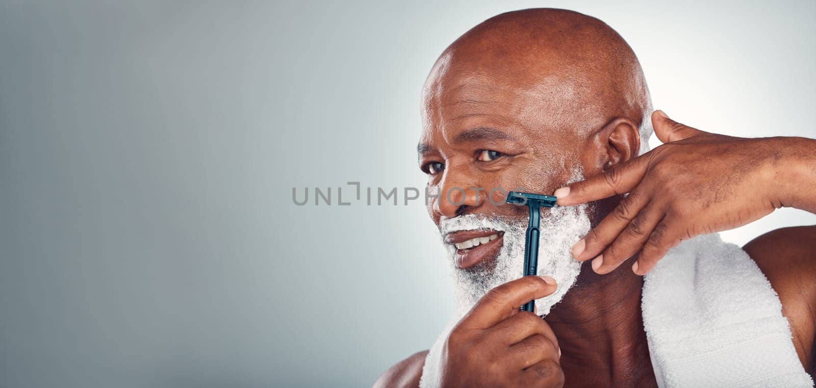 Black man, beard and shaving face in skincare for grooming, self care or facial treatment on mockup. African American male smiling for clean hygiene, shave and cream with razor on a gray background by YuriArcurs