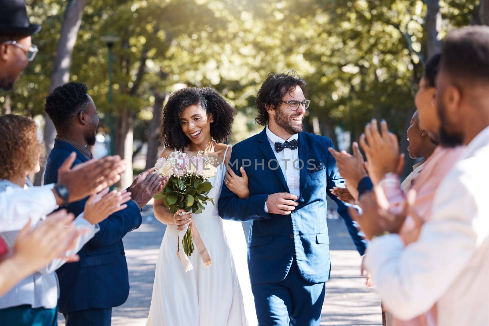Happy celebration and clapping for couple at wedding with excited, joyful and cheerful crowd of guests. Interracial love and partnership of people at marriage event with applause and smile.