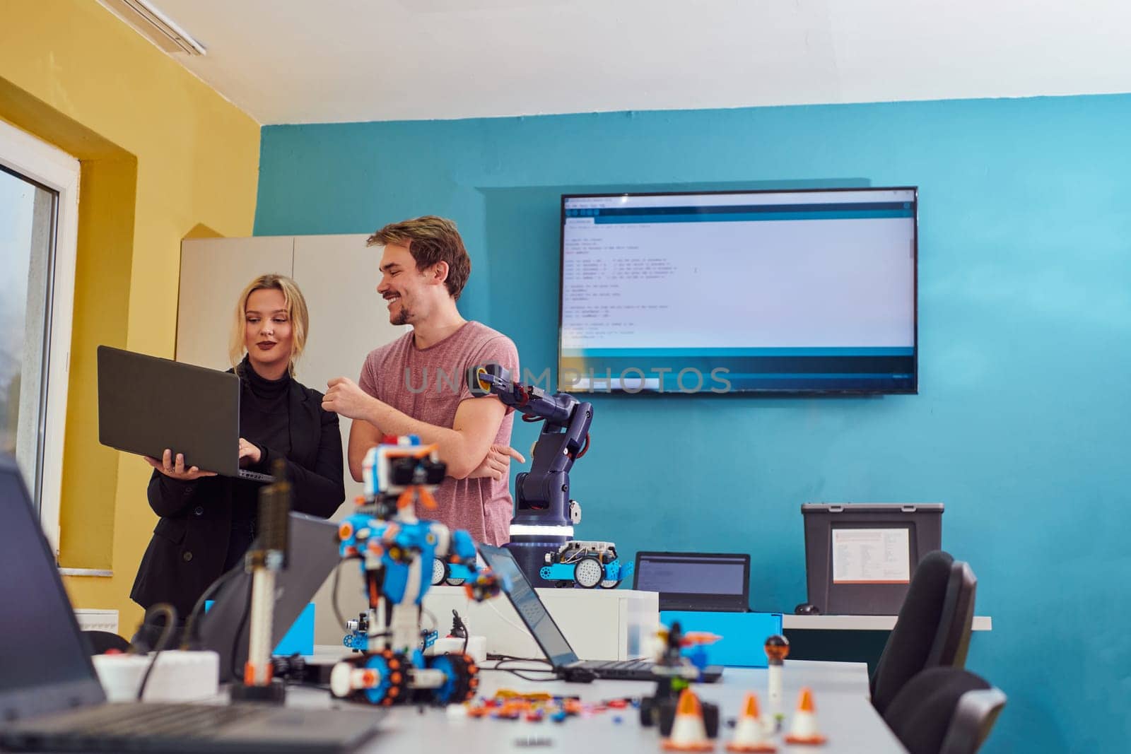 A group of colleagues working together in a robotics laboratory, focusing on the intricate fields of robotics and 3D printing. Showcase their dedication to innovation, as they engage in research, development, engineering, and precision work by dotshock