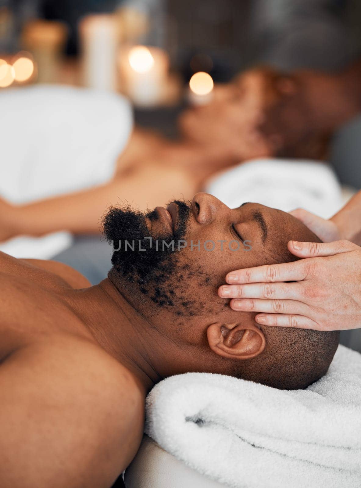 Spa, black man and woman, massage, relax and romantic for peaceful, focus and calm. African American couple, wellness and enjoy retreat for health with luxury holiday, stress relief or lay on table.