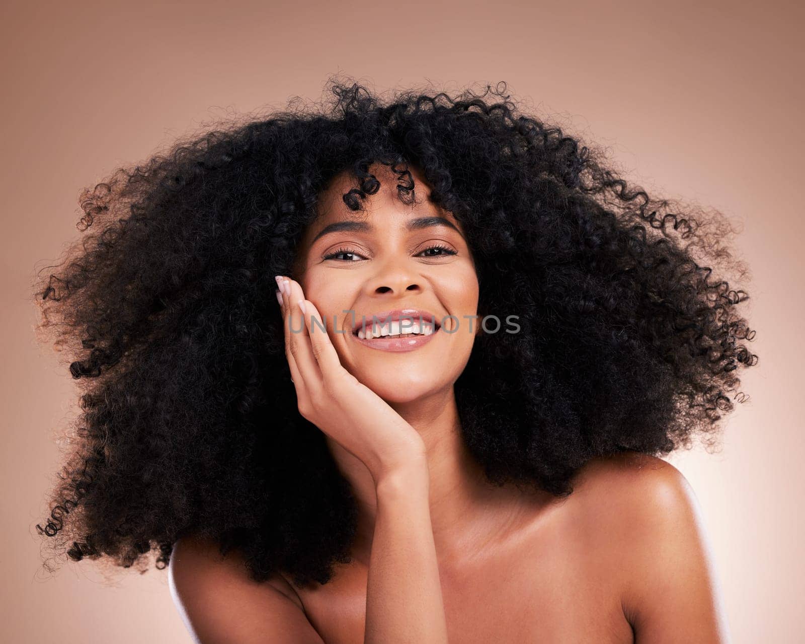 Beauty, hair and face portrait of black woman on brown background for wellness, shine and natural glow. Salon, luxury treatment and happy girl with curly hairstyle, texture and afro growth.