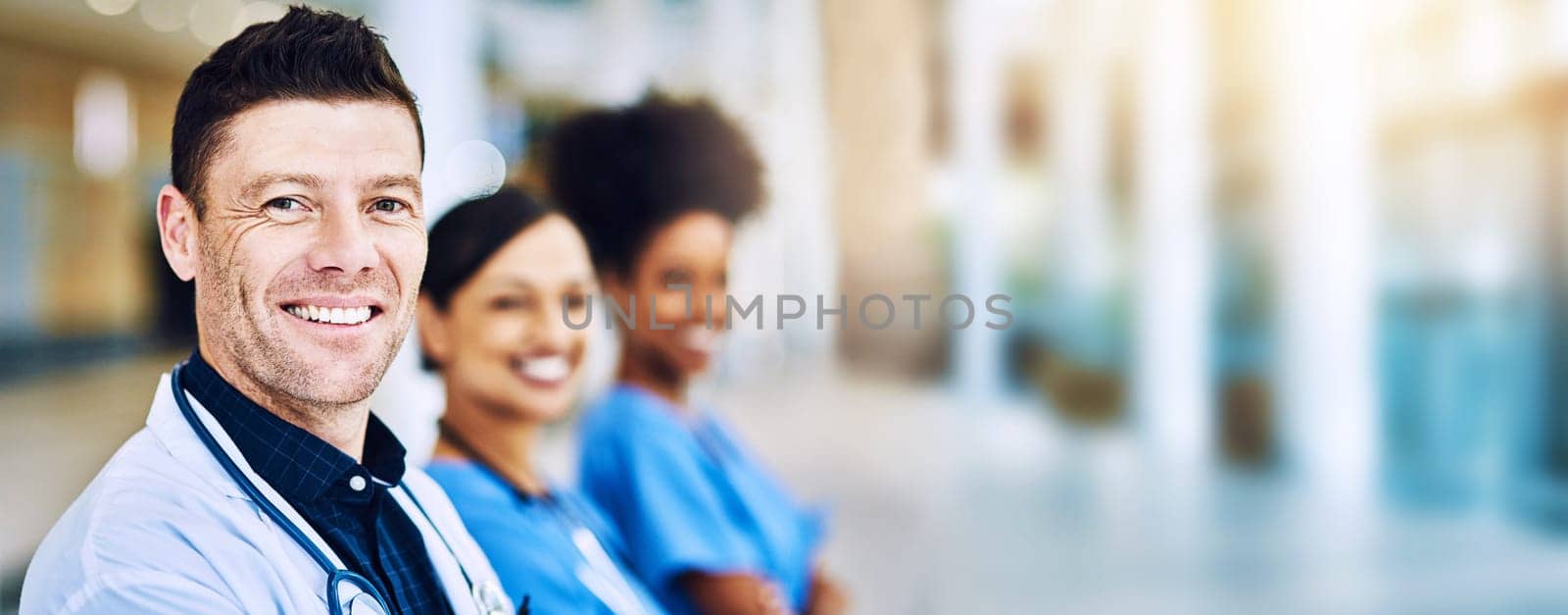 Healthcare, portrait of doctor and nurse team, confident to help with leadership and motivation in hospital or clinic. Diversity, teamwork and man with women medical workers standing together blurred.