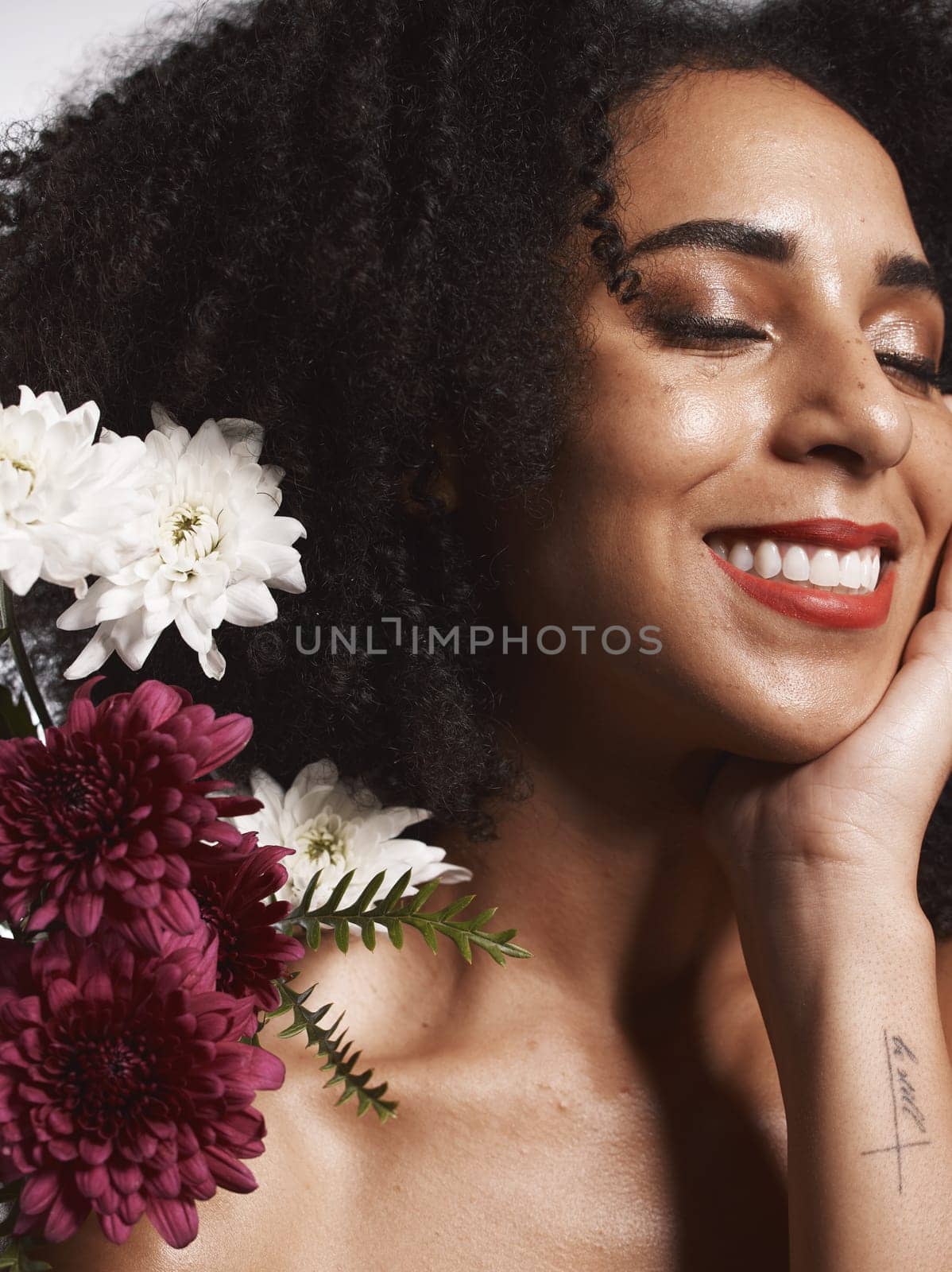 Wellness, flowers and beauty aesthetic model with skincare satisfaction and glowing texture routine. Aesthetic, health and makeup of black woman cosmetics model with beautiful smile in white studio.