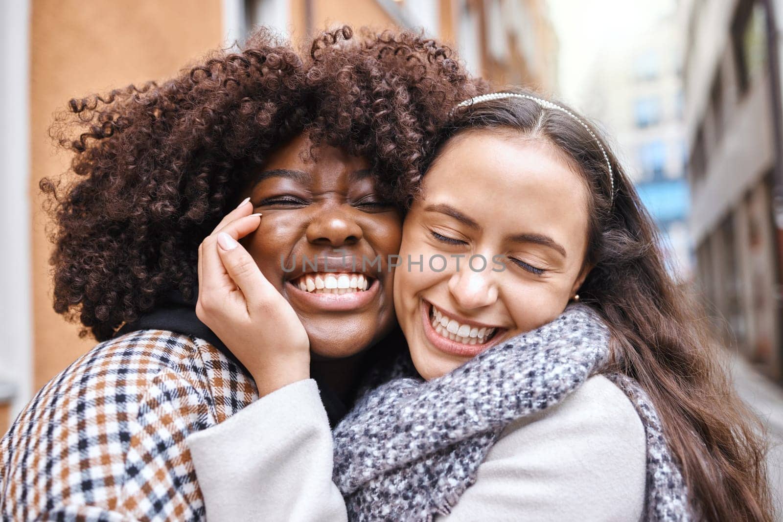Women, friends and hug on street in city with smile, happiness and solidarity by blurred background. Young african lesbian, happy couple and embrace with love, romance and valentines day adventure.