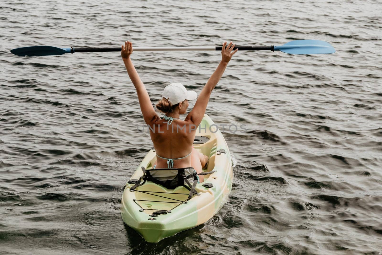 Kayaking. Travel adventure kayak on the tropical sea on a sunny day. Woman rowing a canoe.