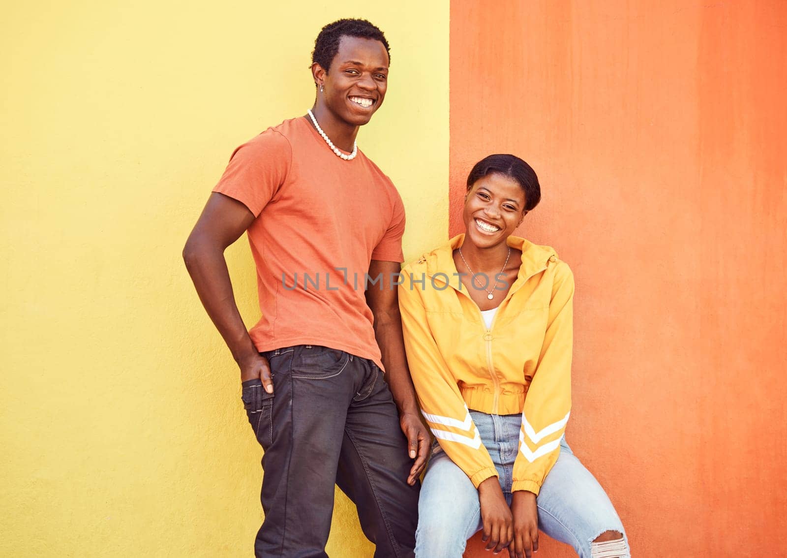 Black couple, smile and urban portrait by wall with edgy fashion, happy and bonding with color. Gen z, happy couple and city wall background with orange, yellow and love on adventure in Atlanta metro by YuriArcurs