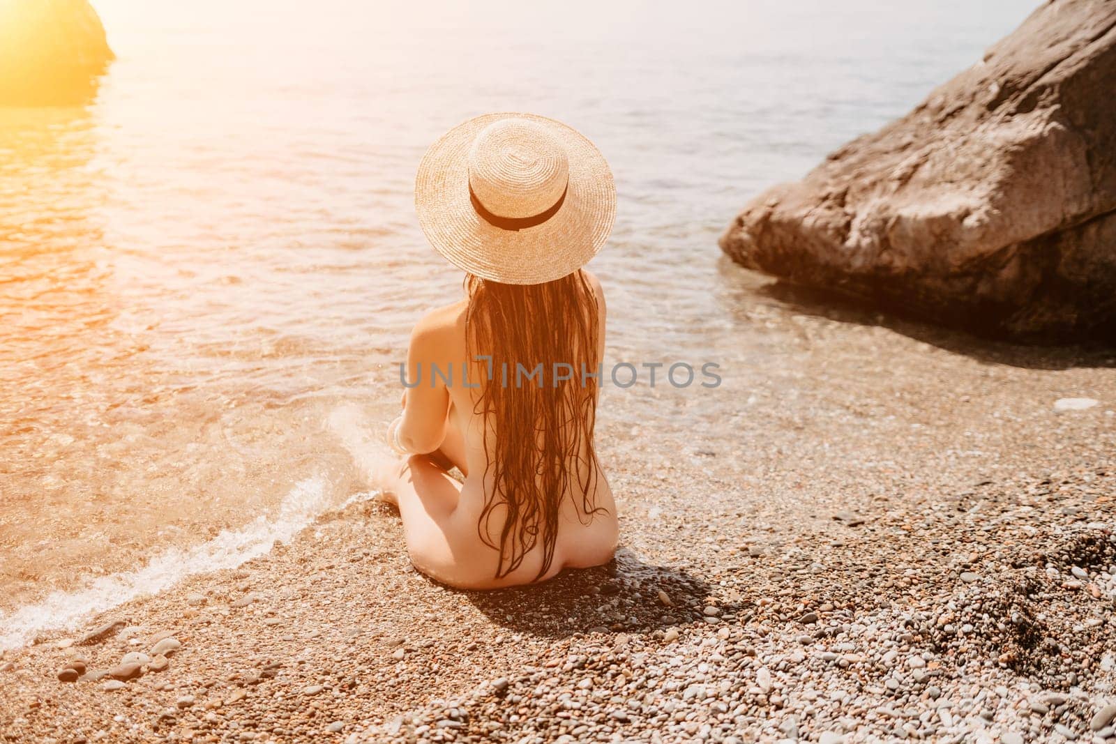 Woman travel sea. Happy tourist in hat enjoy taking picture outdoors for memories. Woman traveler posing on the beach at sea surrounded by volcanic mountains, sharing travel adventure journey by panophotograph