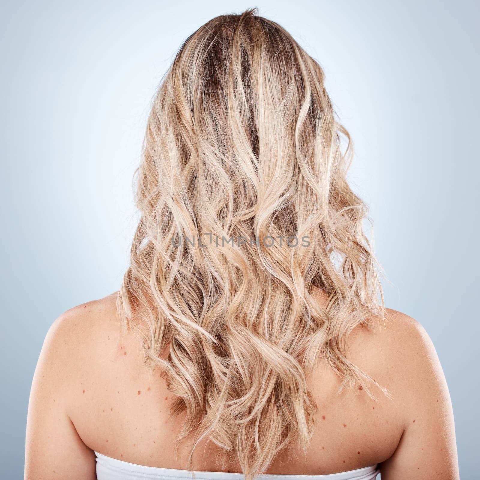 Hair care, beauty and back of woman in studio on a gray background. Balayage, hairstyle and female model with long, blonde and healthy hair after salon or cosmetics hair treatment for hair texture