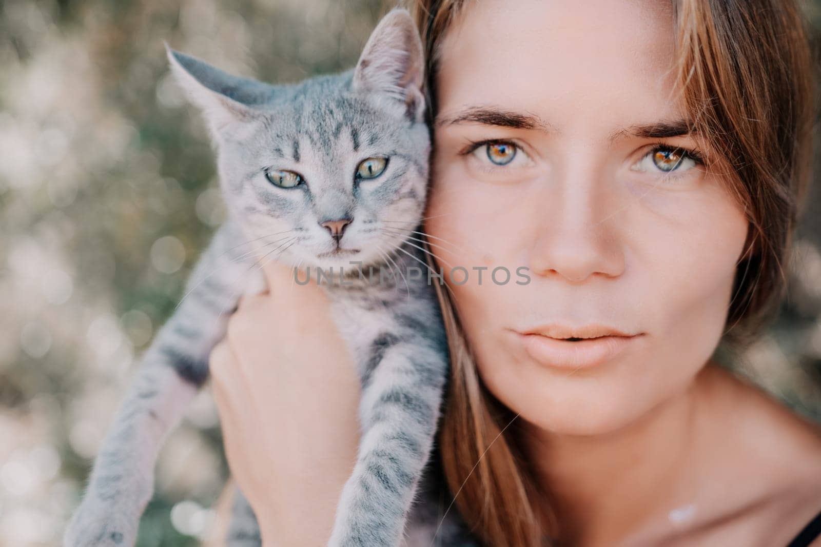 Woman summer travel cat. A woman on vacation with her pet cat enjoying a photo session on the beach. Travel and holiday concept. by panophotograph