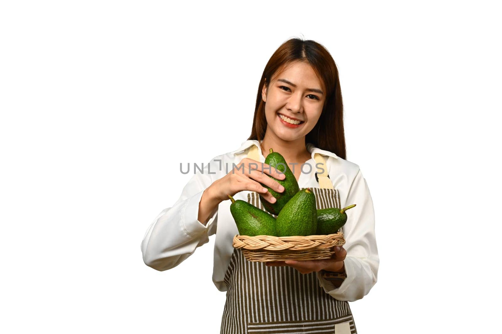 Beautiful woman holding ripe avocado in basket isolated on white background. Vegan food, healthy lifestyle concept.