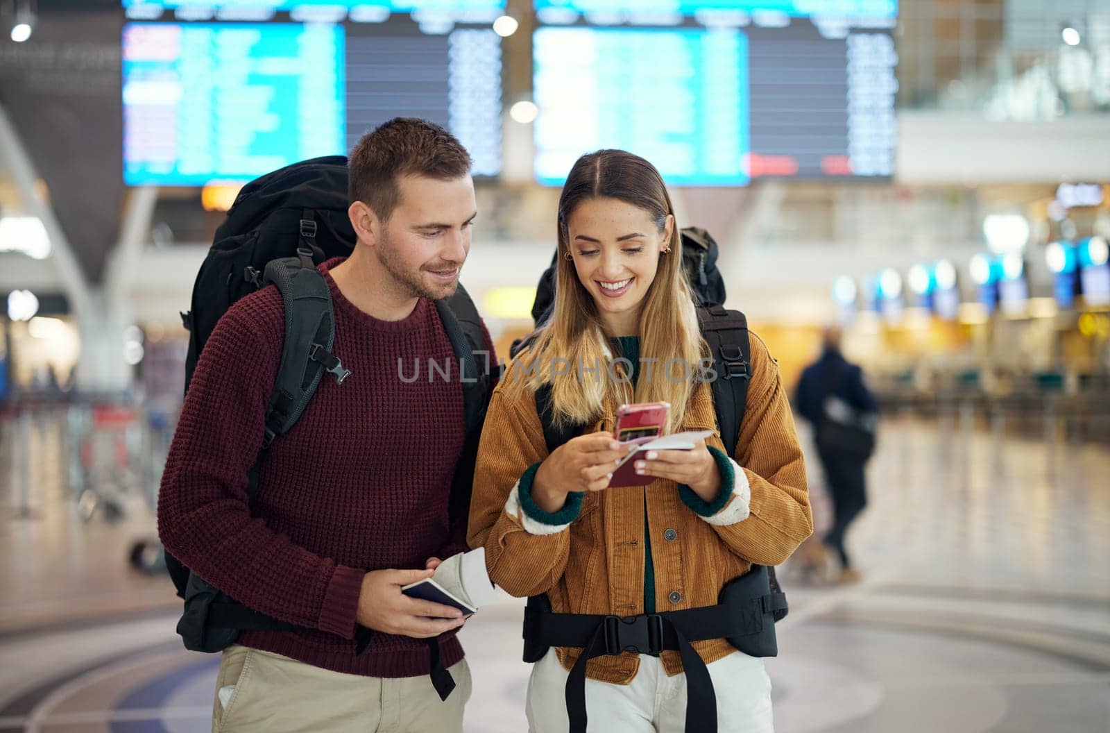 Happy couple, airport and phone with ticket, travel app and adventure with excited face, conversation and smile. Man, woman and smartphone for digital booking of hotel, taxi or bus for transportation.