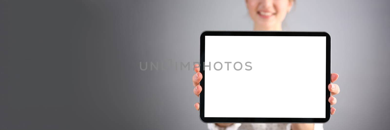 Beautiful smiling businesswoman is holding digital tablet by kuprevich