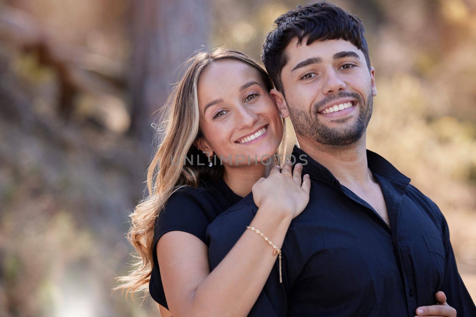 Couple, hug and portrait smile in nature for bonding, love and care in happiness for relationship outdoors. Happy woman hugging man smiling for travel, date or romance together in the park or forest.
