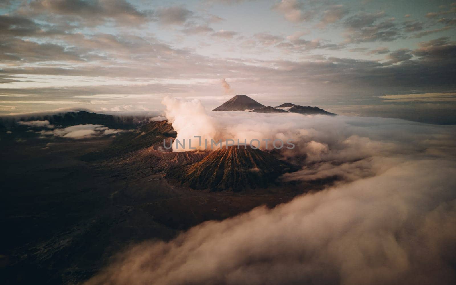 Landscape view of misty mount Bromo volcano. Foggy morning in the java national park with mount Semeru