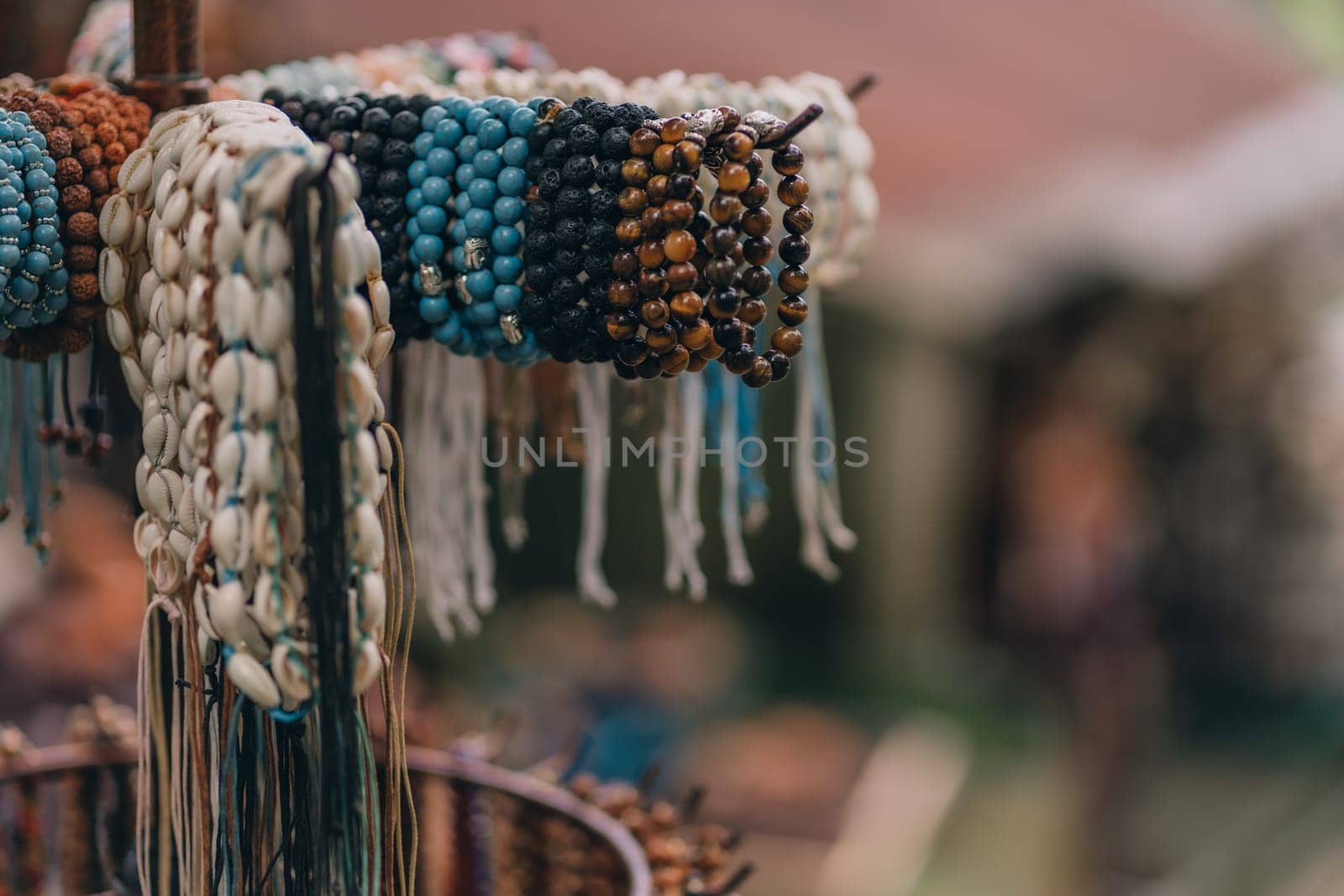 Close up shot of handmade souvenir bracelets. Ethnic wooden handmade jewelry at traditional market